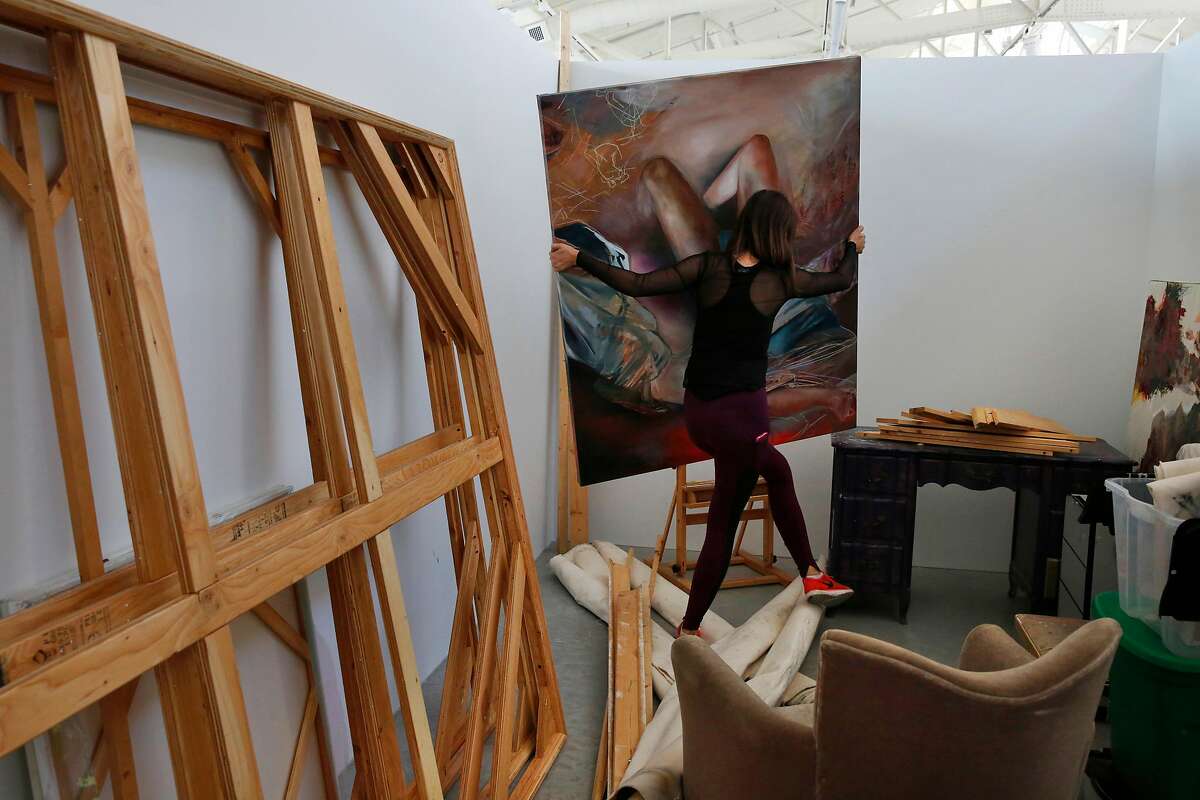 Second year MFA student Katherine Boxall arranges her work in her new studio space after spending the entire day moving her things to San Francisco Art Institute's new campus inside the remodeled historic Herbst Pavilion at the Fort Mason Center for Arts & Culture August 22, 2017 in San Francisco, Calif.