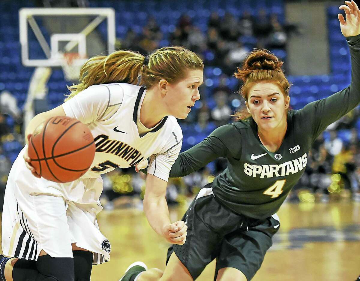 Quinnipiac junior guard Carly Fabbri drives to the paint as Michigan State freshman guard Taryn McCutchon defends, in a 71-54 win for the Spartans in a non-conference game December 6, 2016 at the TD Bank North Sports Center at Quinnipiac University in Hamden.