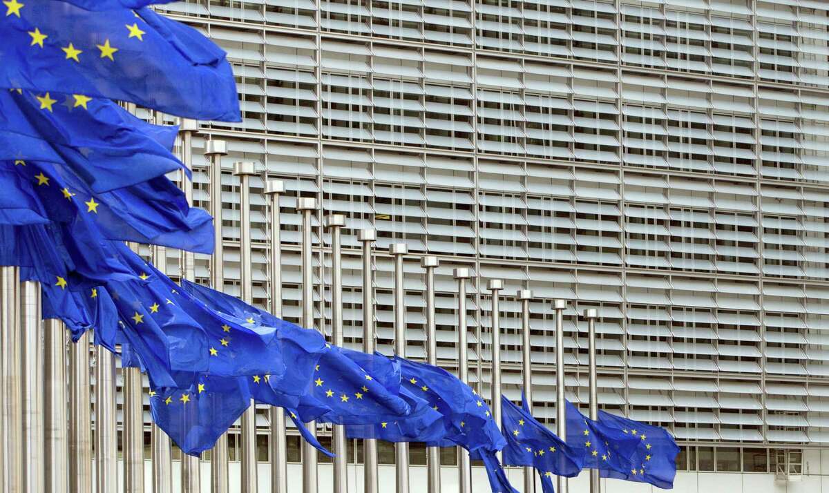 European Union flags blow in the wind at half-staff outside EU headquarters in Brussels on Tuesday, May 23, 2017. The flags were set at half-staff to remember those killed and injured in the attack at an Ariana Grande concert in Manchester on Monday night. (AP Photo/Virginia Mayo)