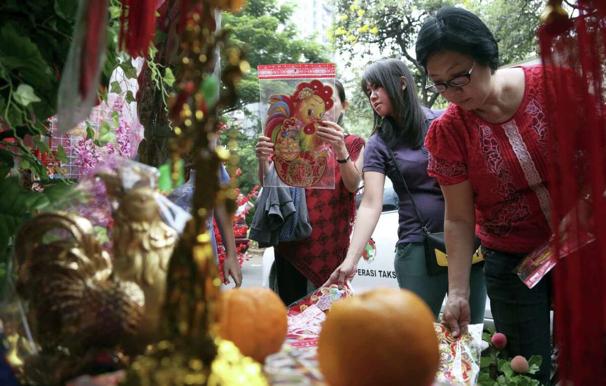 Indonesian ethnic Chinese women buy rooster decorations for Chinese New Year celebrations at the Chinatown in Jakarta, Indonesia on Friday. Chinese worldwide are preparing to celebrate the Year of the Rooster.