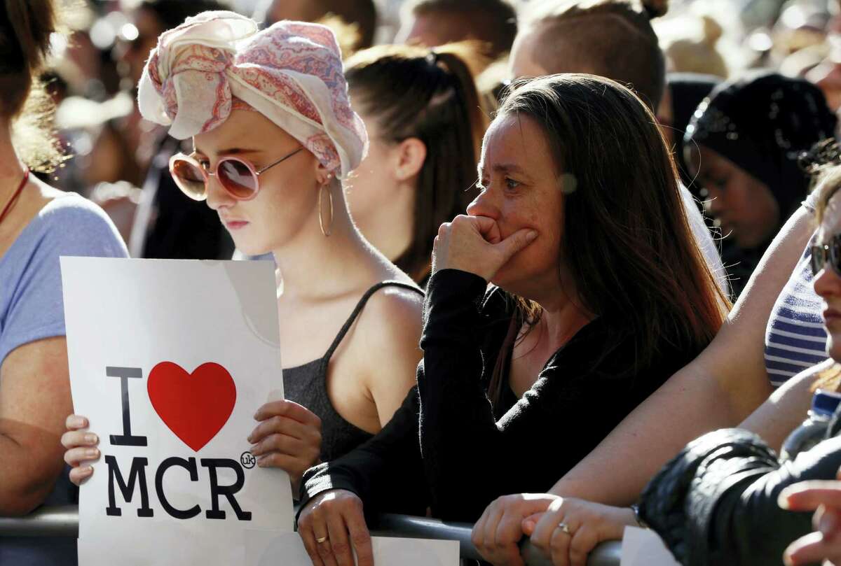People attend a vigil in Albert Square, Manchester, England, Tuesday May 23, 2017, the day after the suicide attack at an Ariana Grande concert that left 22 people dead as it ended on Monday night.
