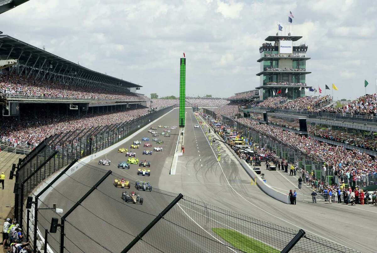 The field rolls into the first turn during the 100th running of the Indianapolis 500 last year.