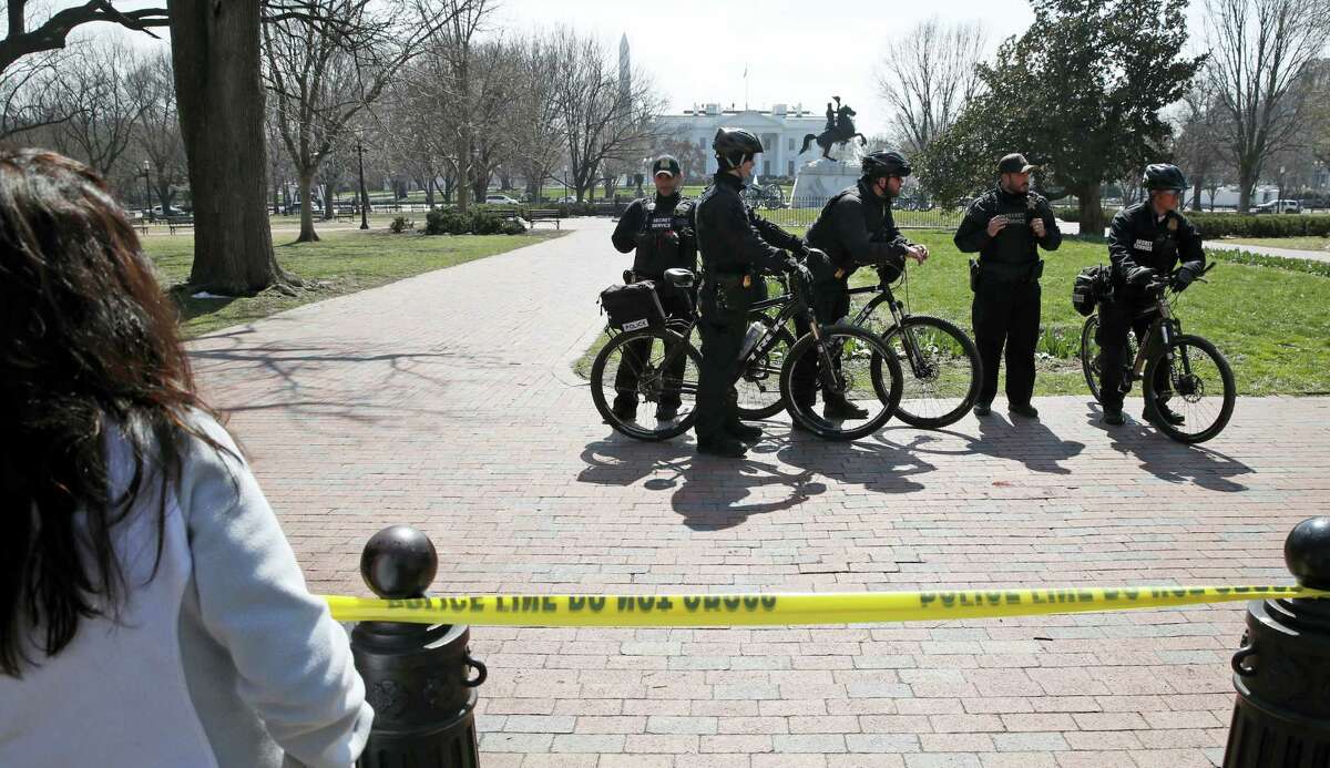 AP Photo/Alex Brandon US Secret Service officers stand in the cordoned off Lafayette Park after a security incident near the fence of the White House in Washington, Saturday, March 18, 2017. President Trump was not at the White House at the time of the incident.