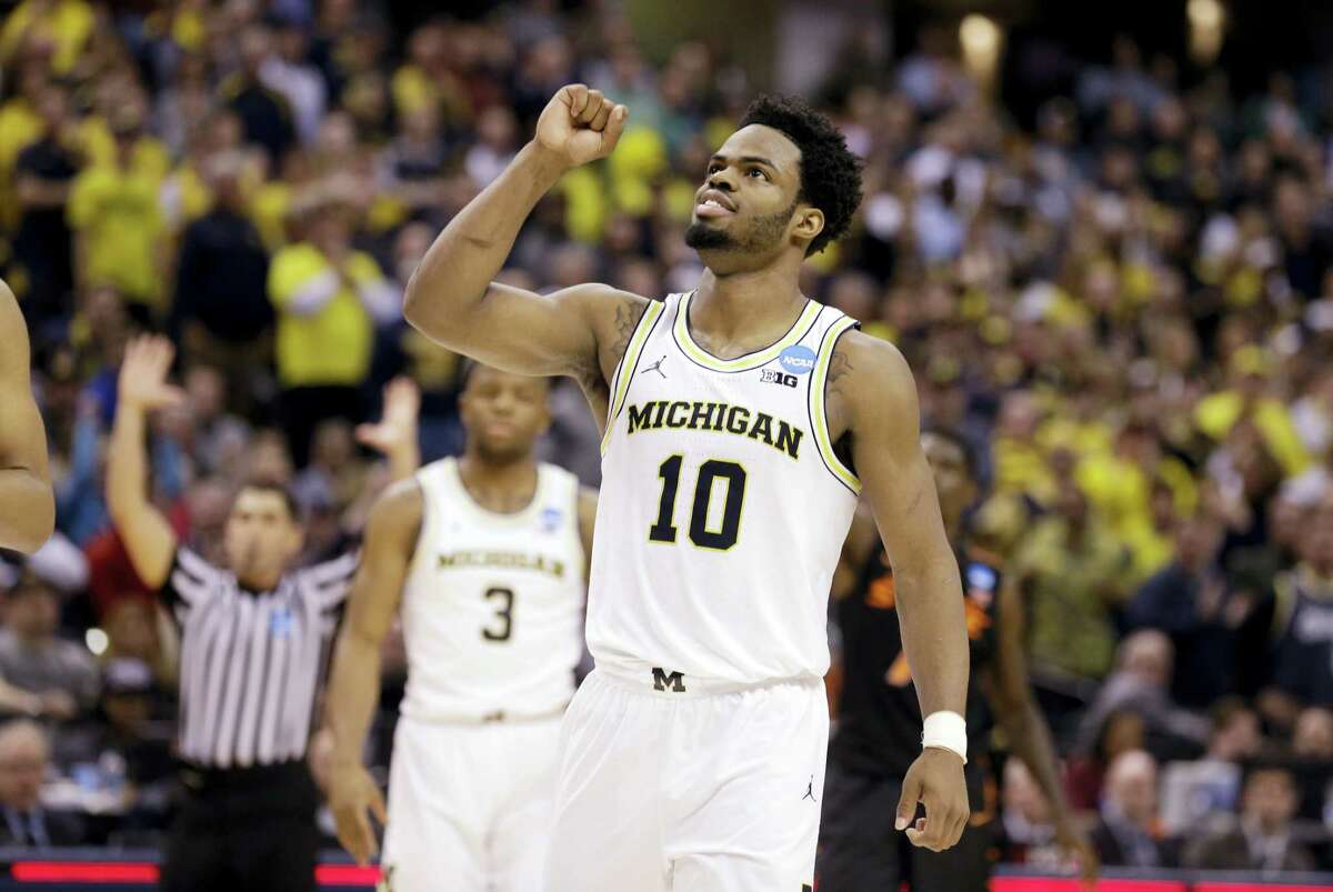 Michigan guard Derrick Walton Jr. (10) celebrates after their win over Oklahoma State on Friday.