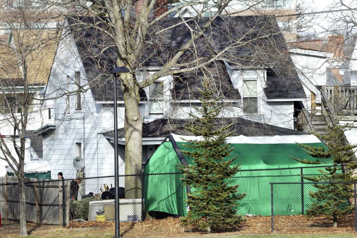 A large green tent is seen in the back of a house on Hayward Street in Manchester, N.H., where authorities searched for clues in the missing person’s case of Denise Beaudin. State authorities said the case is connected to one involving four bodies found in two steel drums between 1985 and 2000 in a state park. Beaudin’s family last saw her on Thanksgiving 1981, when she was 23, with her boyfriend, Robert “Bob” Evans, and her infant daughter.
