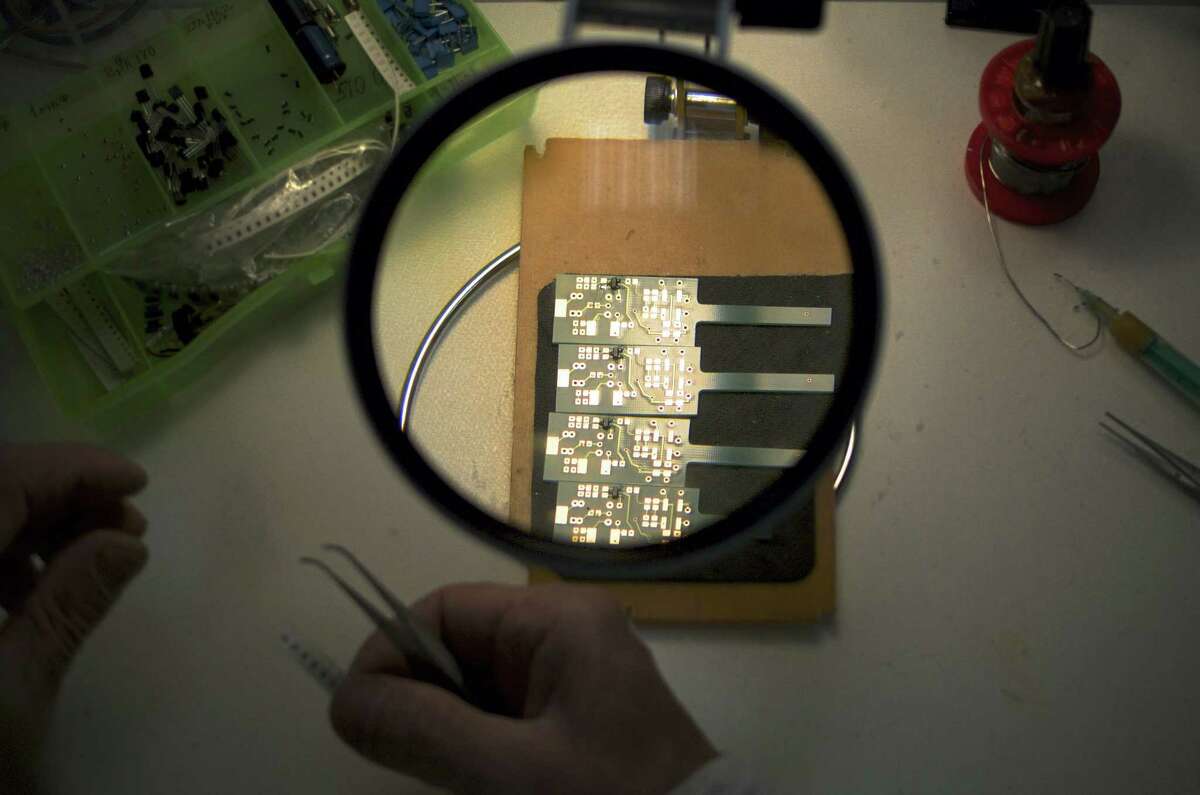 Sergei Savishchev solders electronic components at a factory in Tula, Russia.