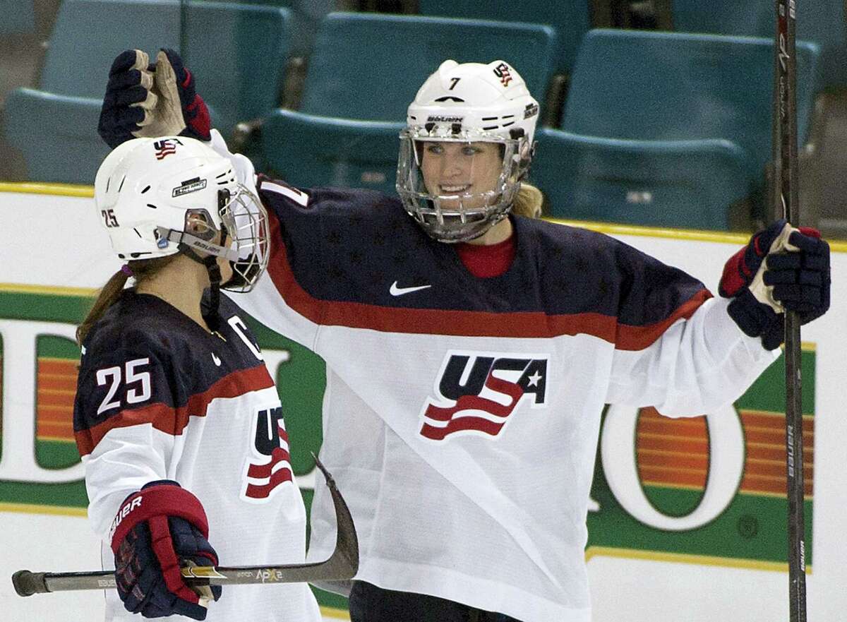 In this Nov. 4, 2014 photo, Team United States’ Monique Lamoureux, right, celebrates her goal against Team Finland with teammate Alex Carpenter during the third period at the Four Nations Cup women’s hockey tournament in Kamloops, British Columbia. The U.S. women’s hockey team is threatening to boycott the world championships because of a wage dispute. The team announced Wednesday that they will not participate in the International Ice Hockey Federation tournament that begins March 31, 2017 in Plymouth, Michigan.