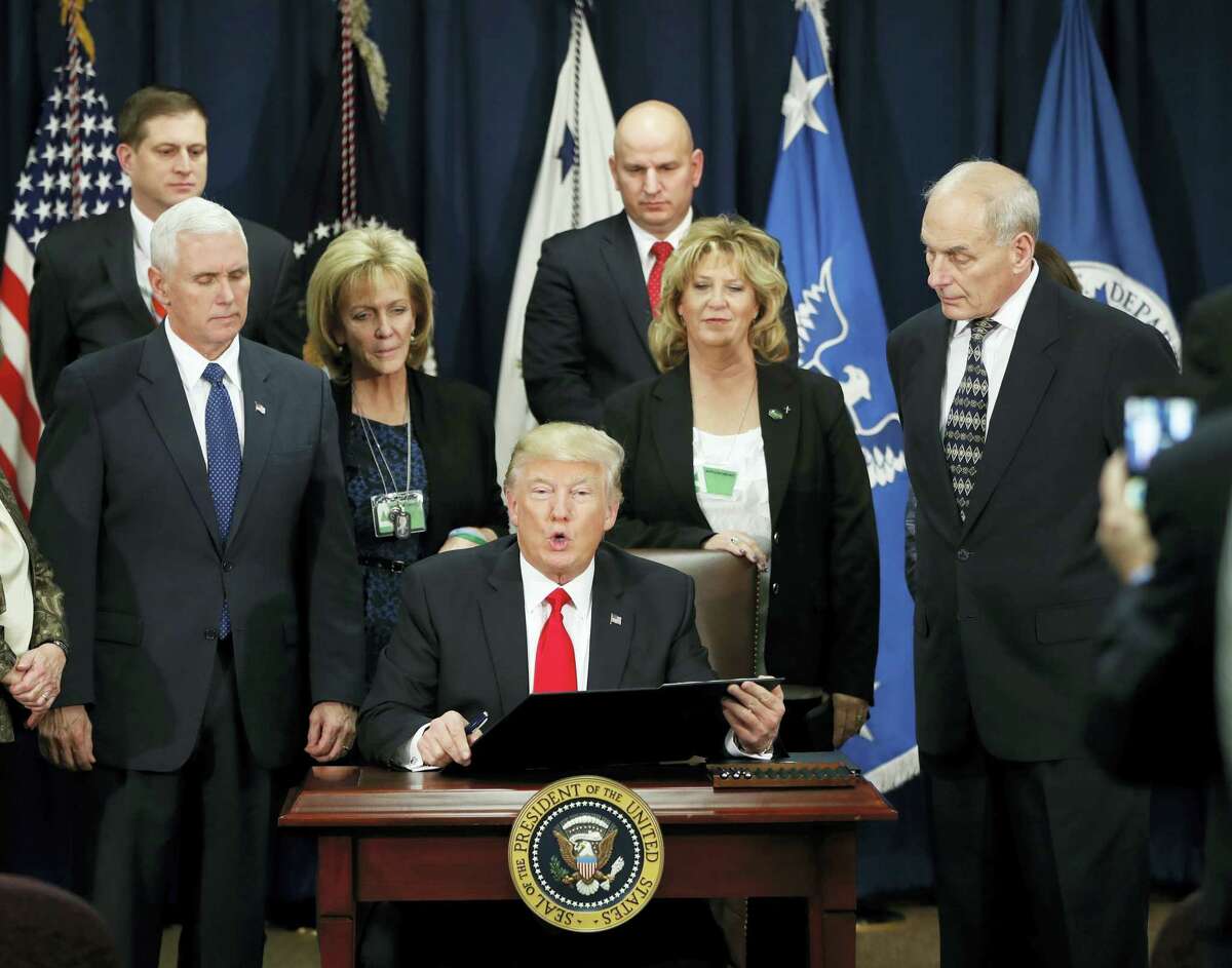 President Donald Trump, accompanied by Vice President Mike Pence, Homeland Security Secretary John F. Kelly, and others, speaks during a visit to the Homeland Security Department in Washington on Wednesday.