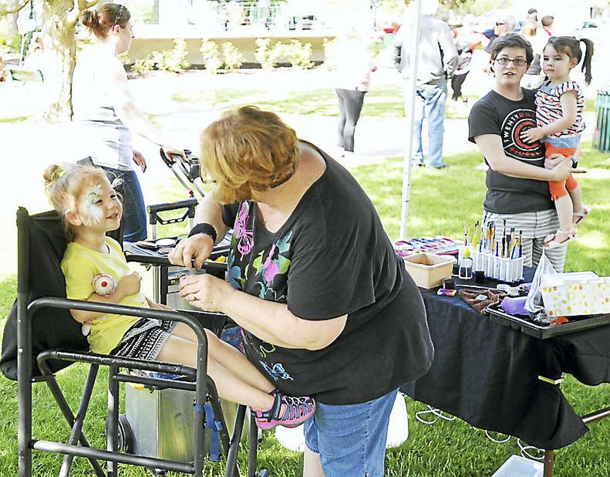 Ava Smigel has her face painted during the ice cream social at East End Park in Winsted Friday.