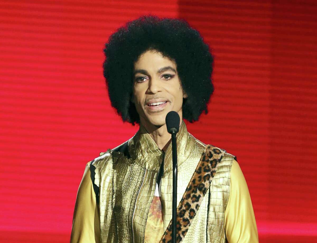 In this Nov. 22, 2015, file photo, Prince presents the award for favorite album - soul/R&B at the American Music Awards in Los Angeles. People magazine reported online on March 15, 2017, that Prince’s ex-wife says is opening up about the couple’s baby who died just six days after being born with a rare genetic disorder in 1996. Mayte Garcia writes in a new memoir that baby Amiir was born in Oct. 1996 with Pfeiffer syndrome type 2, a disorder that causes skeletal abnormalities.