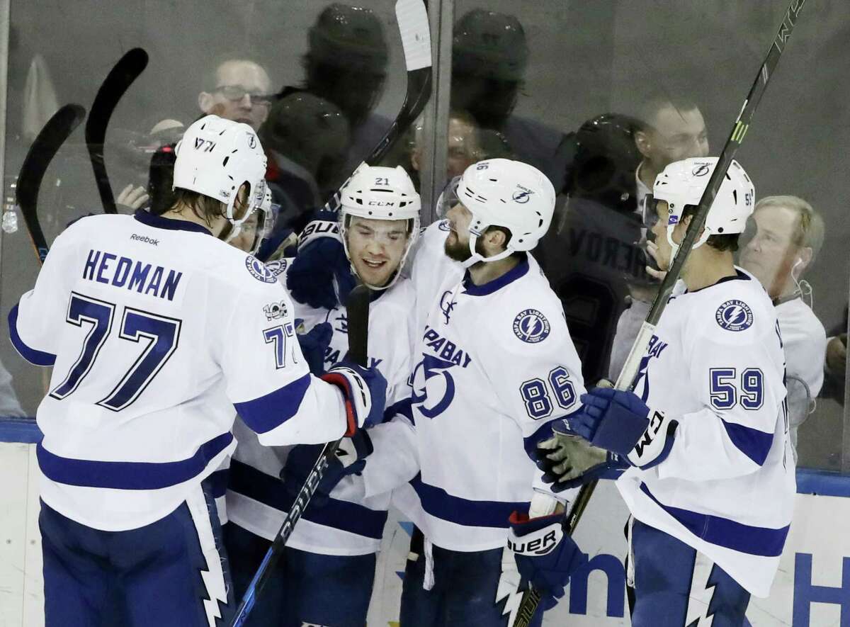 Tampa Bay Lightning’s Brayden Point (21) celebrates with teammates Victor Hedman (77), Nikita Kucherov (86) and Jake Dotchin (59) after scoring a goal during the third period of an NHL hockey game against the New York Rangers Monday, March 13, 2017, in New York. The Lightning won 3-2.