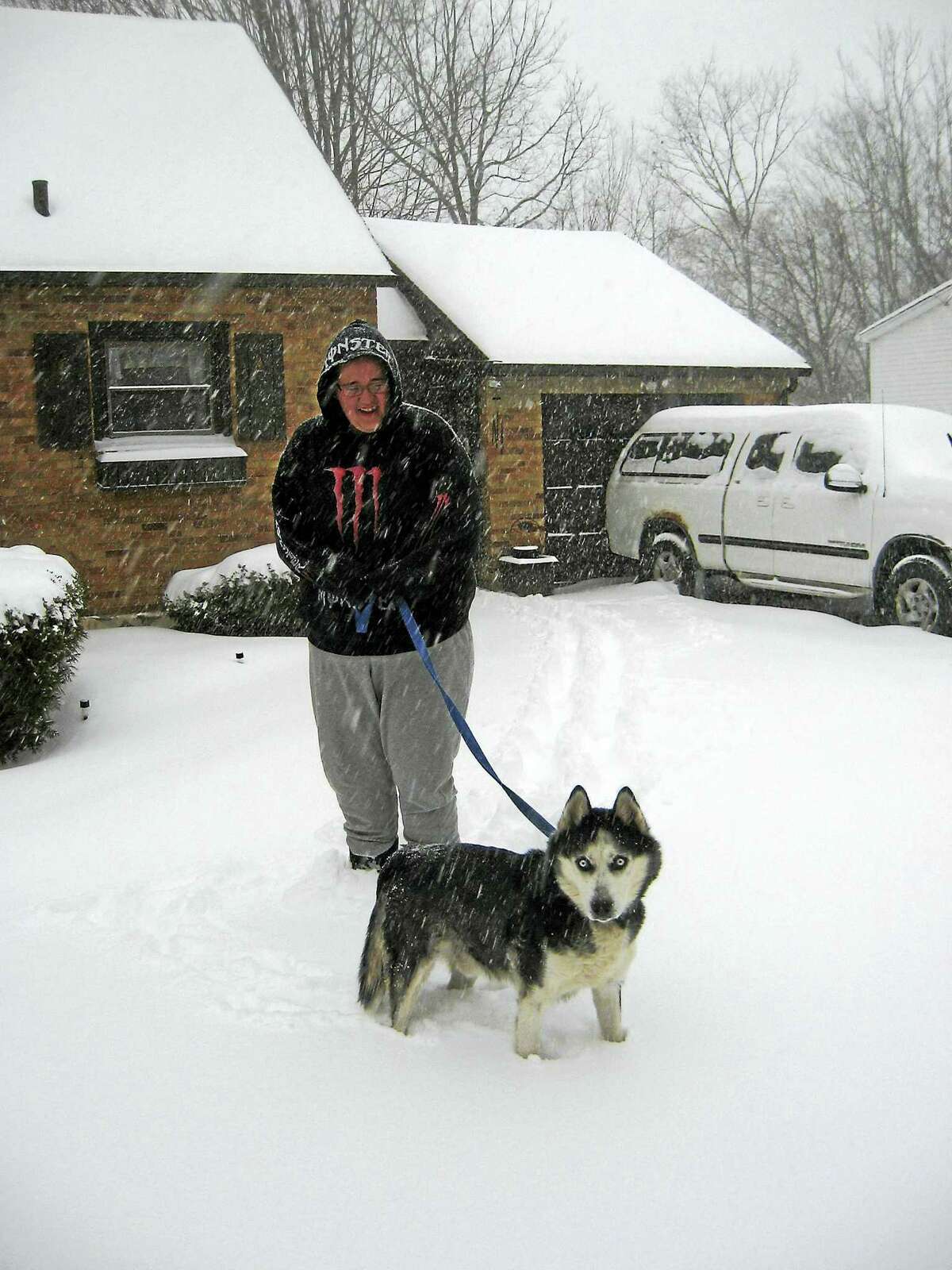 Torrington resident Brittany Beyus and her dog, Kobe, brave the storm on Tuesday morning.
