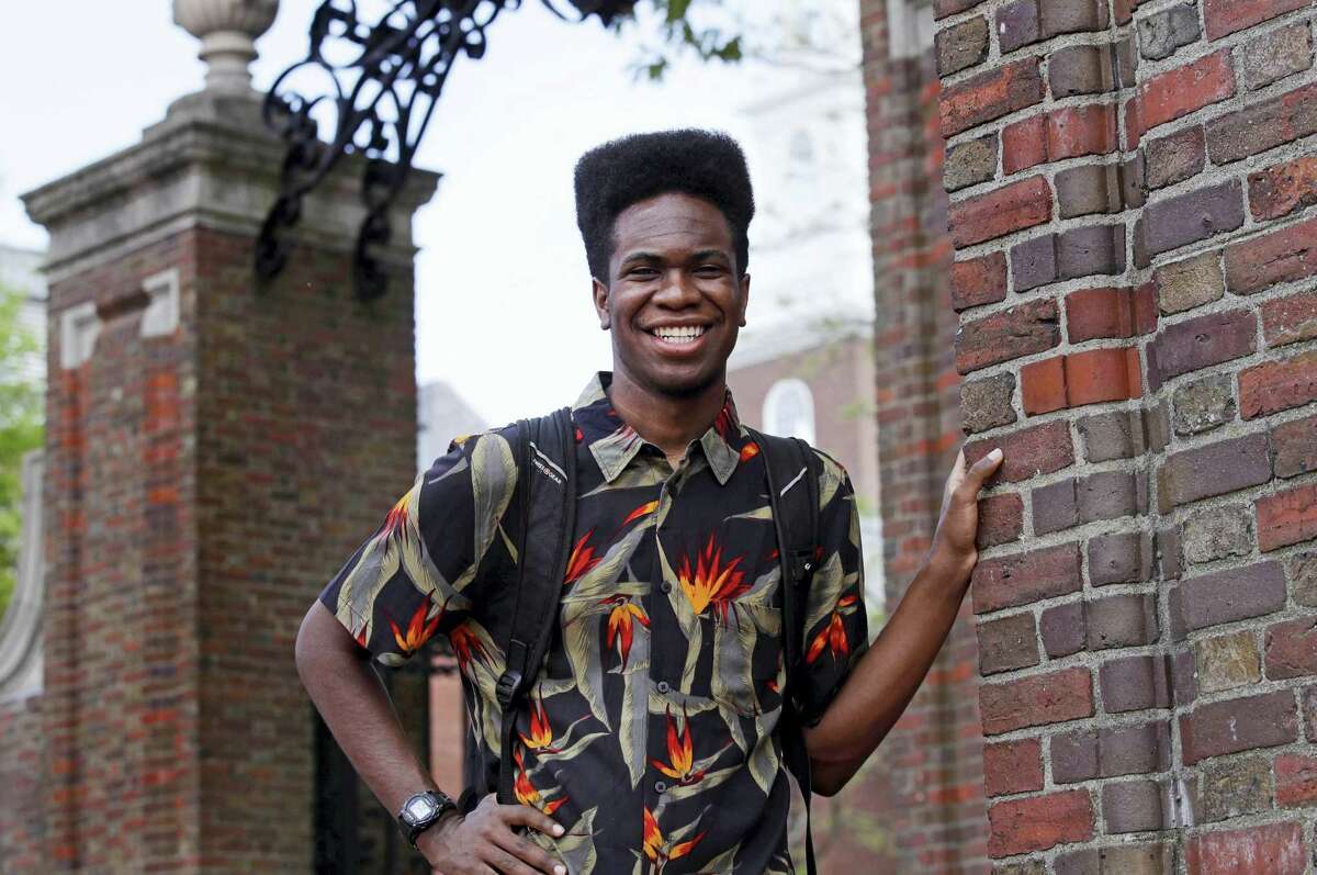 Obasi Shaw poses outside the gates of Harvard Yard in Cambridge, Mass., Thursday, May 18, 2017. Shaw, an English major who graduates from Harvard next week, is the university’s first student to submit his final thesis in the form of a rap album. The record, called “Liminal Minds,” has earned the equivalent of an A- grade, good enough to ensure that Shaw will graduate with honors at the university’s commencement next week.