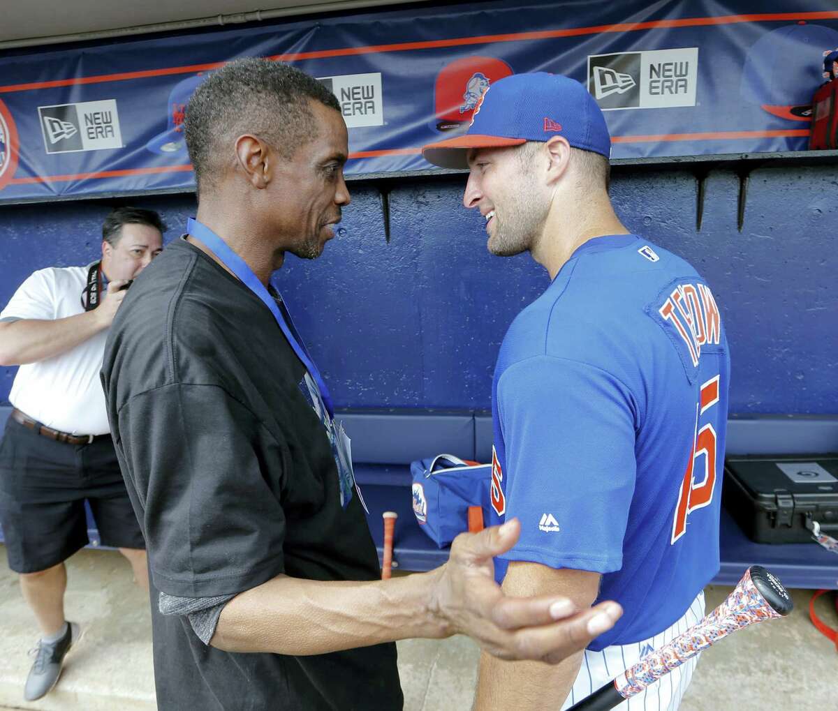Tim Tebow, right, talks with former Mets pitcher Dwight Gooden before a spring training game Monday in Port St. Lucie, Fla.