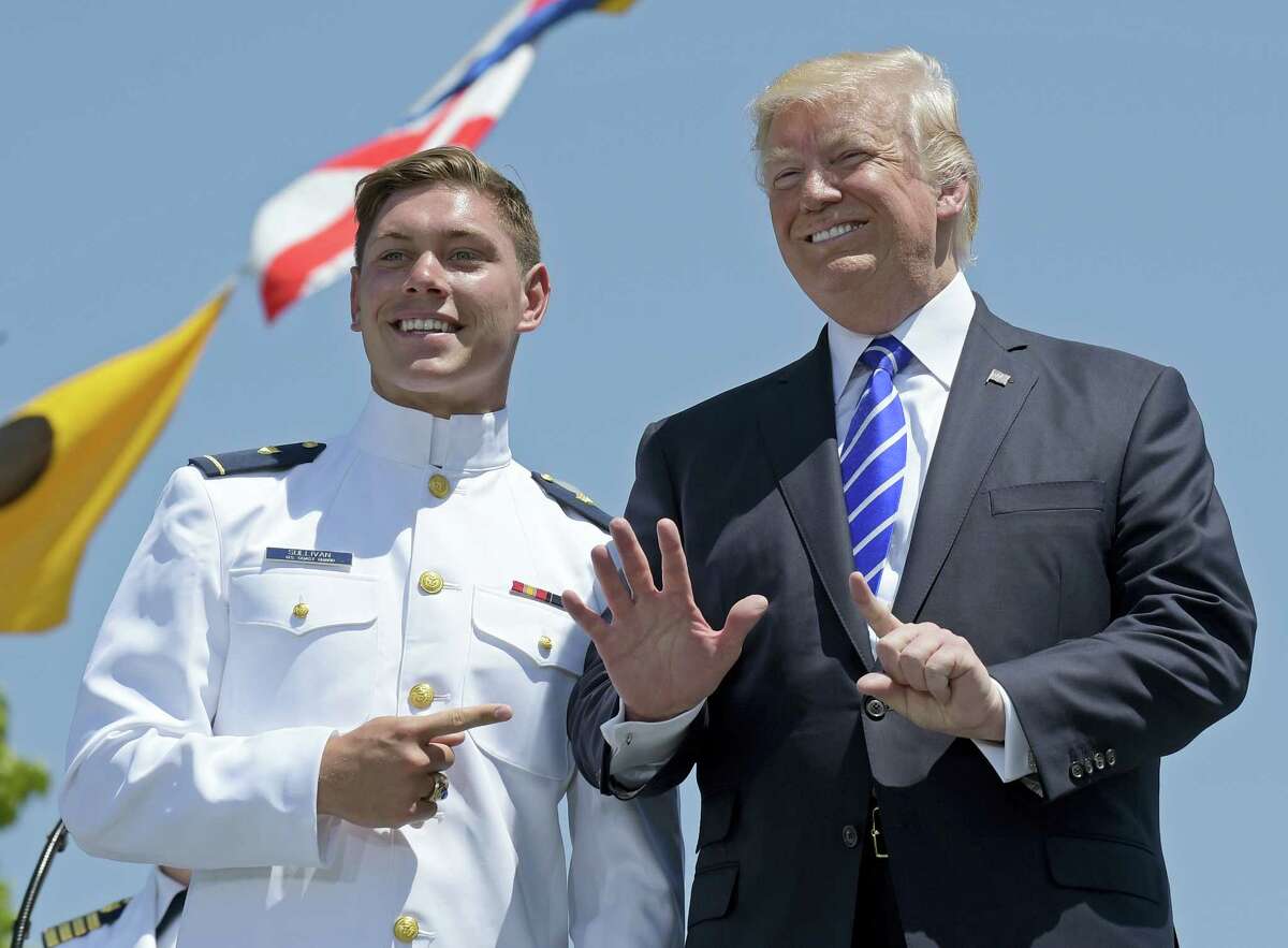 President Donald Trump poses for a photo with U.S. Coast Guard Academy graduate Brendan Ryan Sullivan during commencement exercises at the U.S. Coast Guard Academy in New London, Conn., Wednesday.