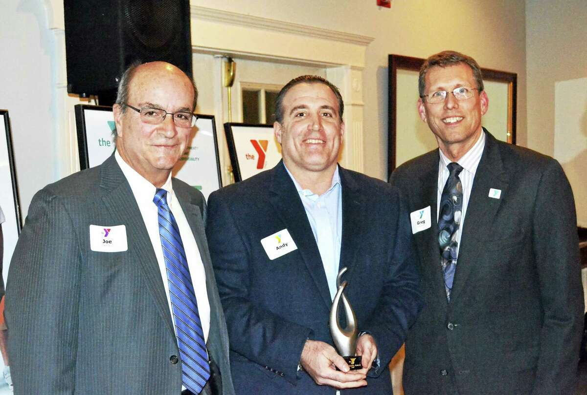 Northwest CT YMCA Board President Joseph Greco, left, and CEO Greg Brisco, right, present Andy Maiolo, general manager of Center Subaru, with the President’s Award at the Y’s annual recognition reception. The event was held at Crystal Peak in Winsted.