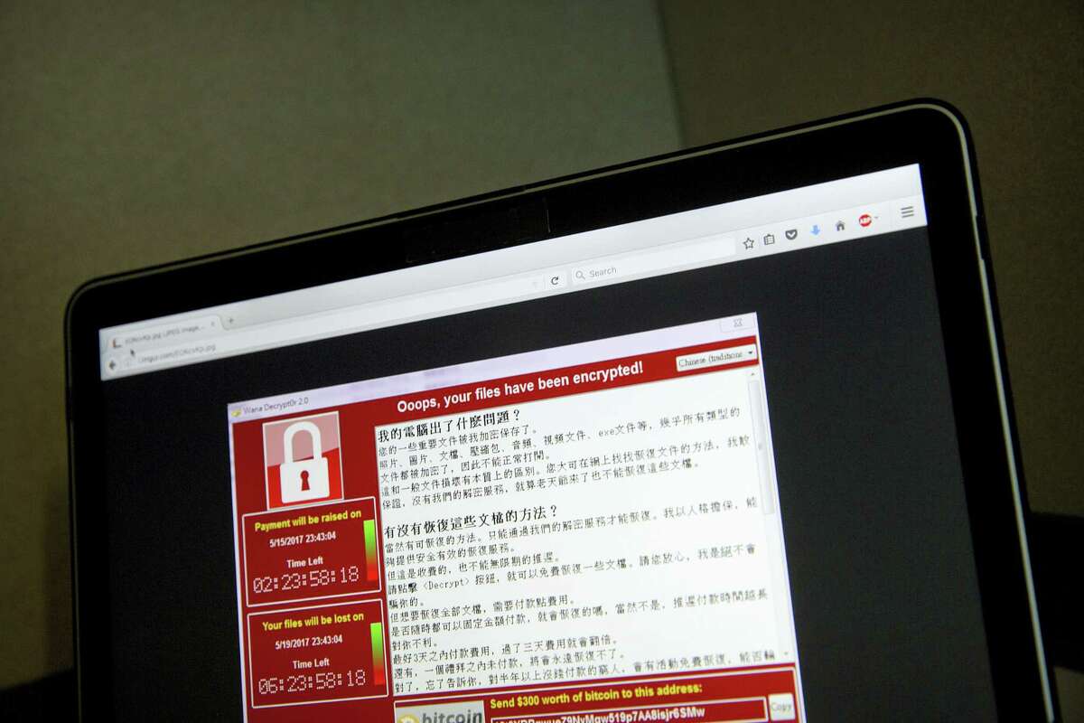 In this May 13, 2017, file photo, a screenshot of the warning screen from a purported ransomware attack, as captured by a computer user in Taiwan, is seen on laptop in Beijing. Global cyber chaos is spreading Monday, May 14, as companies boot up computers at work following the weekend’s worldwide “ransomware” cyberattack. The extortion scheme has created chaos in 150 countries and could wreak even greater havoc as more malicious variations appear. The initial attack, known as “WannaCry,” paralyzed computers running Britain’s hospital network, Germany’s national railway and scores of other companies and government agencies around the world.