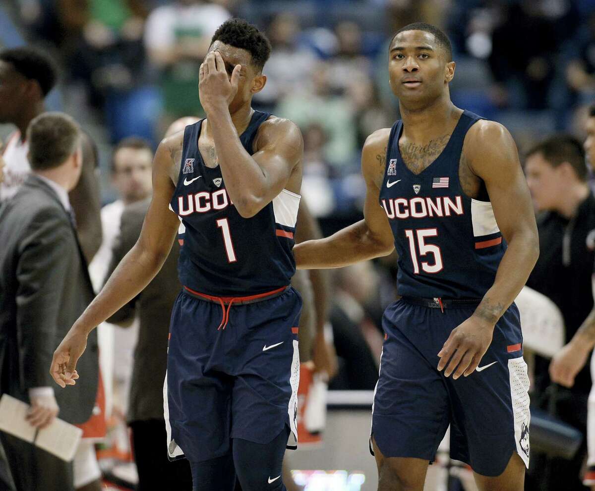 UConn’s Christian Vital, left, and Rodney Purvis react during the second half of Saturday’s loss to Cincinnati.