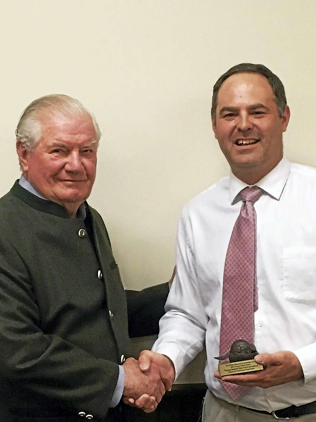 White Memorial Foundation board president Aurthur Diedrick, left, presents the White Memorial Foundation’s Conservation Award to Christopher Brittain, Wamogo’s Agriculture Science and Technology teacher.