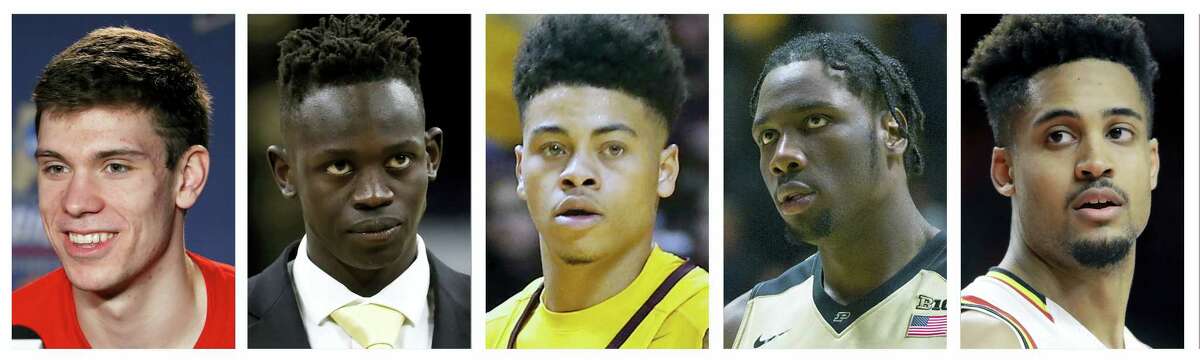 These are file photos showing members of the 2017 AP All-Big Ten NCAA college basketball first team, selected on March 7, 2017. From left are Ethan Happ, Wisconsin; Peter Jok, Iowa; Nate Mason, Minnesota, Calen Swaniga, Purdue and Melo Trimble, Maryland.