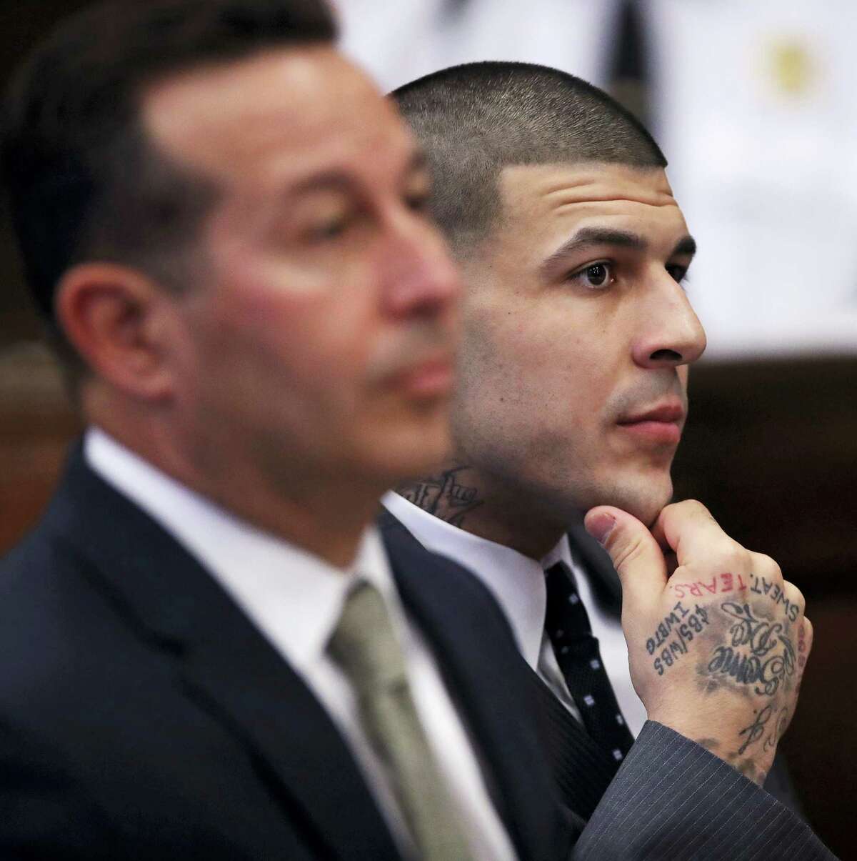Former New England Patriots NFL football player Aaron Hernandez, right, is seated with his defense attorney Jose Baez as they listen during a pretrial hearing at Suffolk Superior Court in Boston on Thursday.