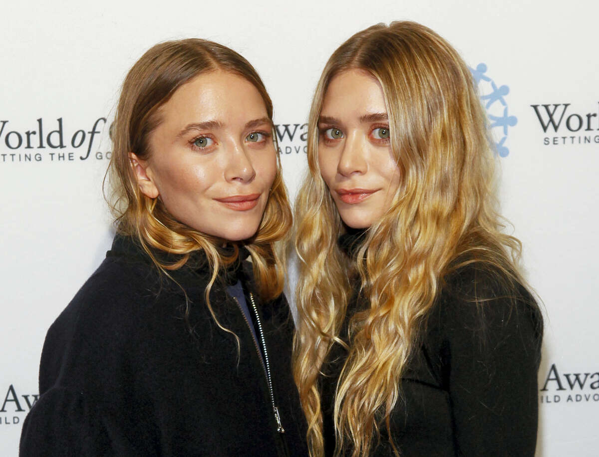 In this Thursday, Nov. 6, 2014, file photo, Mary-Kate Olsen, left, and Ashley Olsen attend the 2014 World of Children Awards at 583 Park Avenue, in New York. Under a proposed settlement filed by attorneys for a former intern in a New York state court on March 3, 2017, the twins’ Dualstar Entertainment Group would pay out up to $140,000 to a group of interns who say they didn’t receive compensation when working for Dualstar.