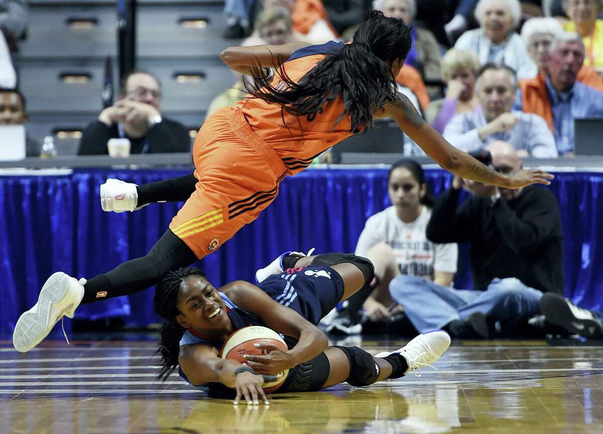 The Sun’s Courtney Williams, top, fouls the Dream’s Tiffany Hayes during the first half Saturday.