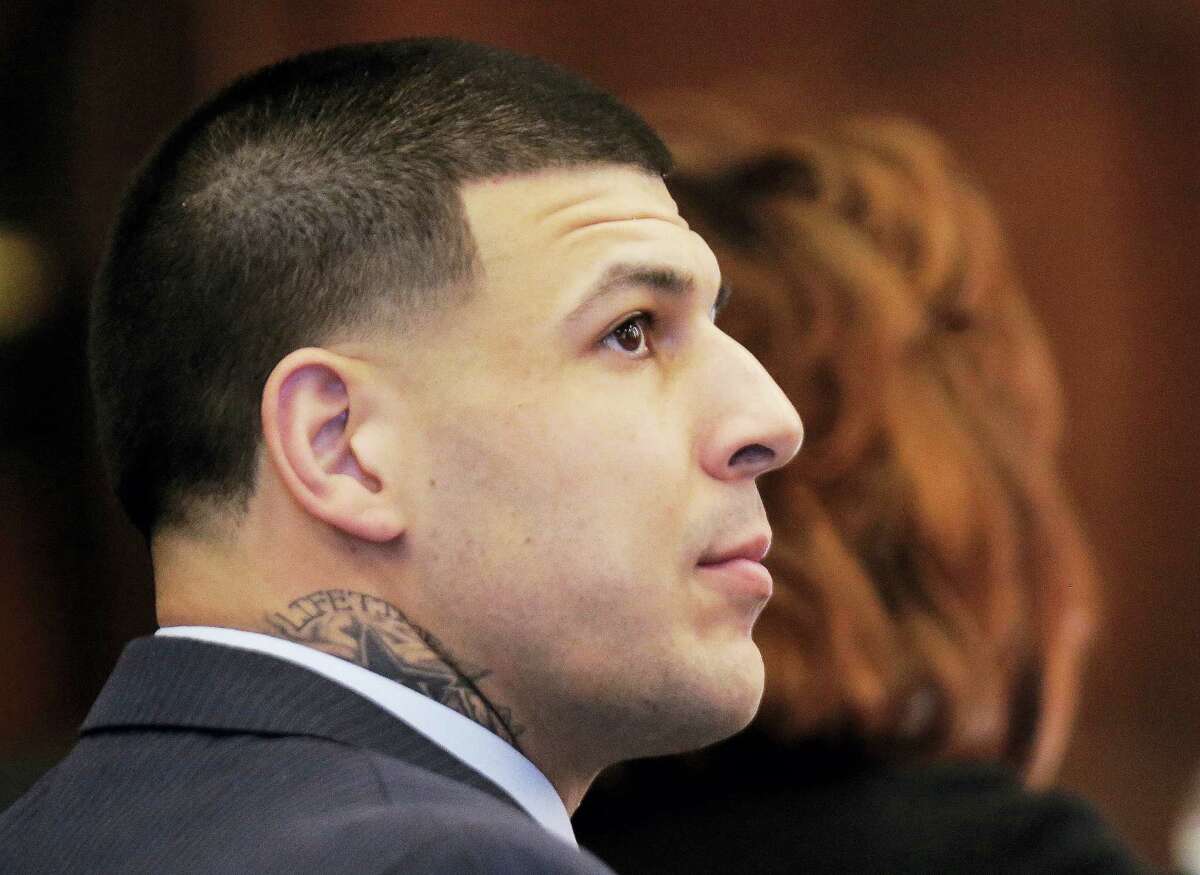 Former New England Patriots tight end Aaron Hernandez watches as defense attorney Ronald Sullivan argues a motion with judge Jeffrey Locke during Hernandez’s double murder trial at Suffolk Superior Court on March 6, 2017 in Boston. Hernandez is standing trial for the July 2012 killings of Daniel de Abreu and Safiro Furtado who he encountered in a Boston nightclub. The former NFL player is already serving a life sentence in the 2013 killing of semi-professional football player Odin Lloyd.