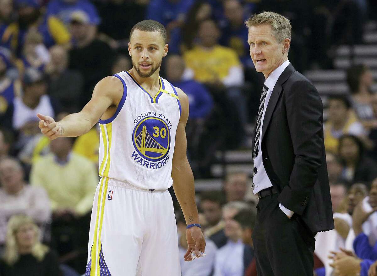 Golden State Warriors guard Stephen Curry (30) talks with head coach Steve Kerr during the first half of an NBA basketball game against the Detroit Pistons in Oakland, Calif. on Jan. 12, 2017.