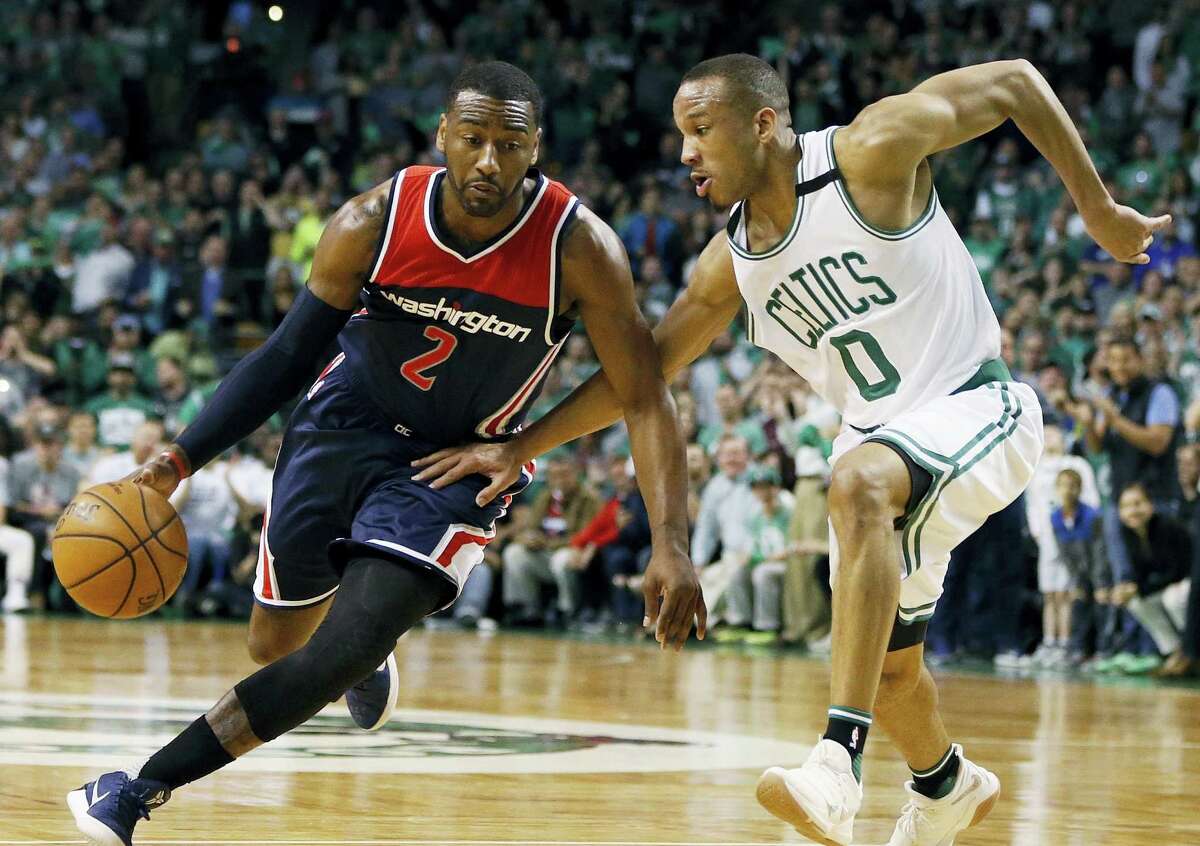 John Wall, left, tries to drive against the Celtics’ Avery Bradley during the third quarter of a second-round NBA playoff series basketball game in Boston.