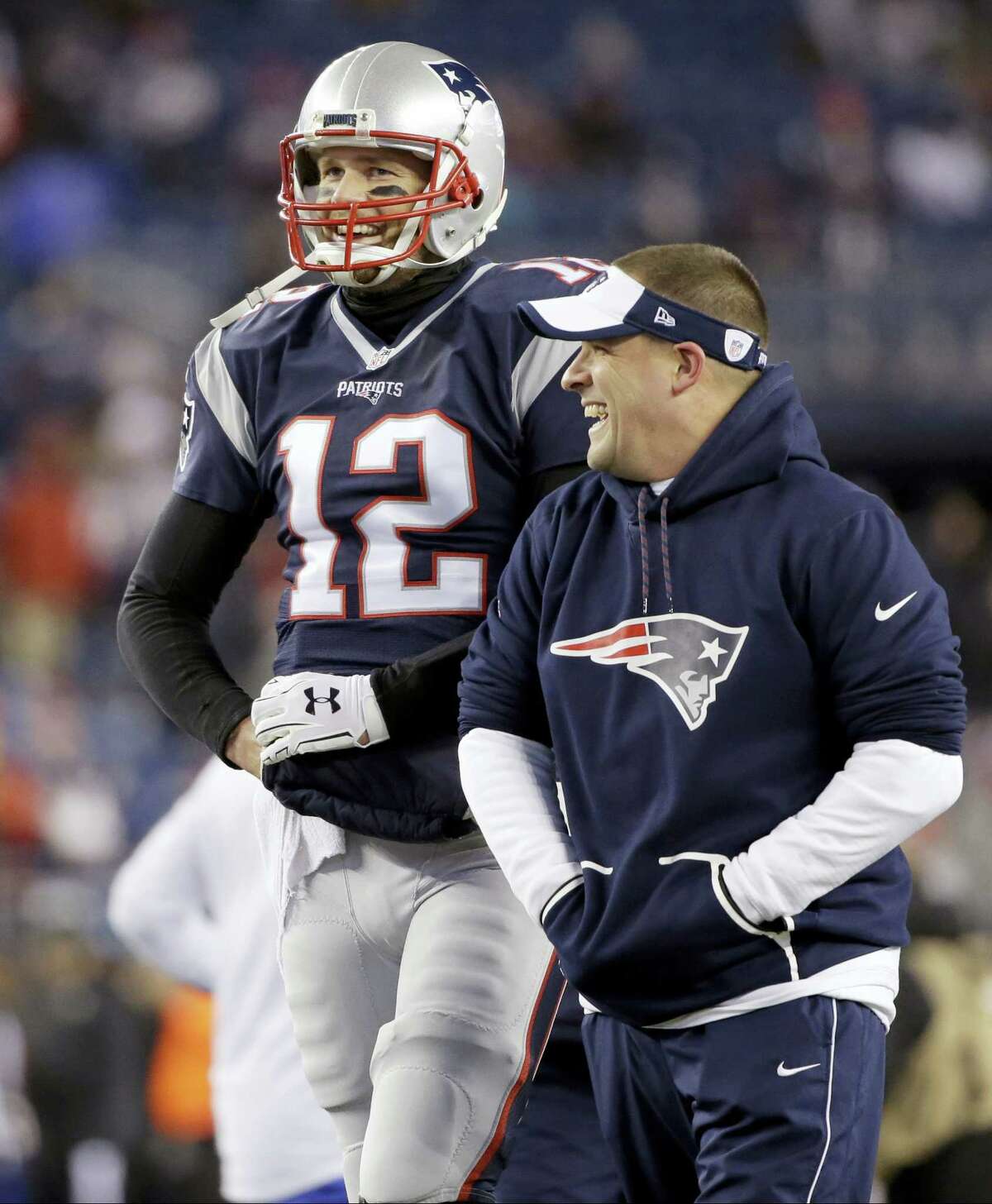 Patriots quarterback Tom Brady, left, talks with offensive coordinator Josh McDaniels.