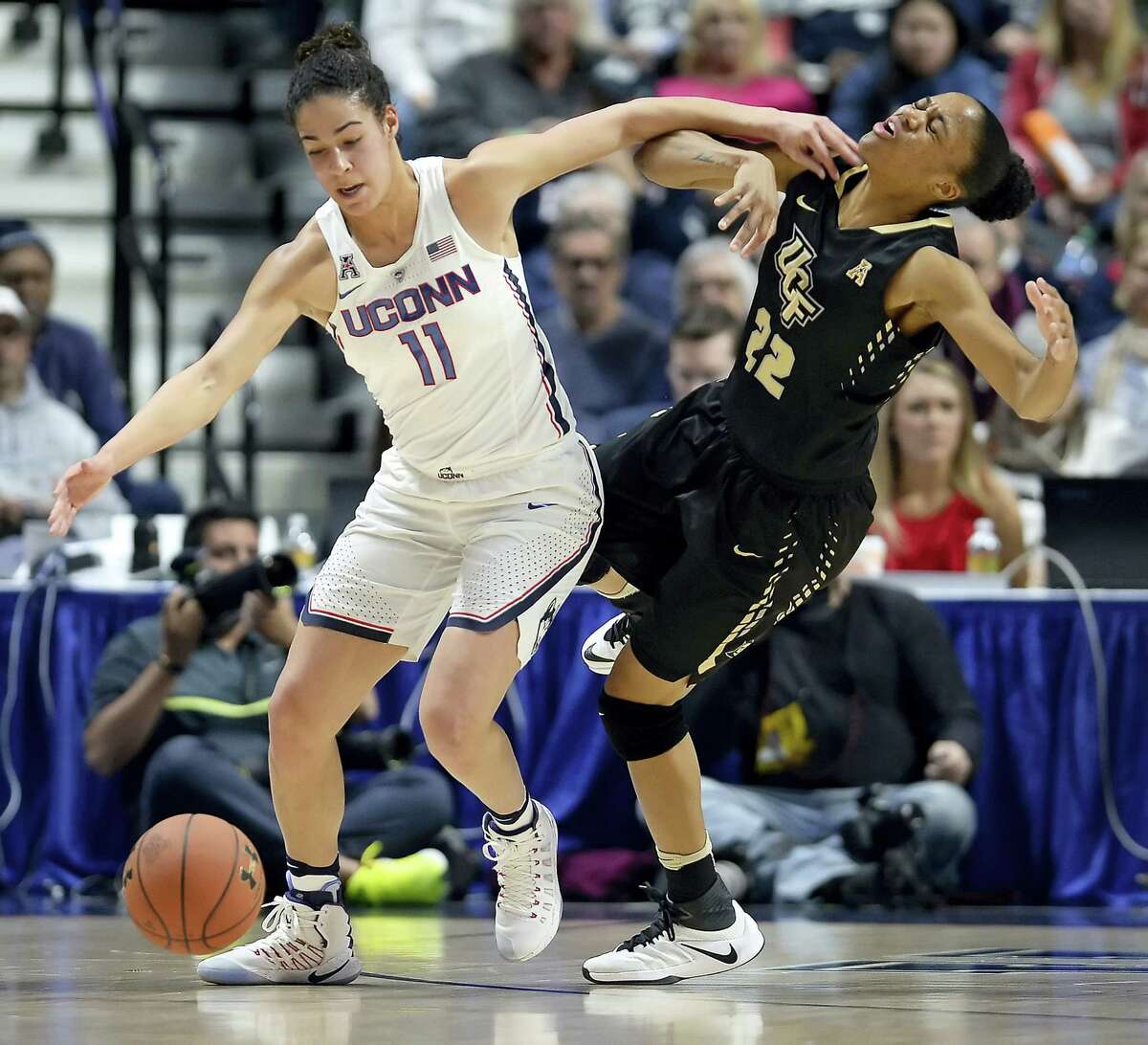 UConn’s Kia Nurse, left, and Central Florida’s Aliyah Gregory, right, battle for a loose ball during the first half Sunday in an AAC semifinal at Mohegan Sun Arena in Uncasville.