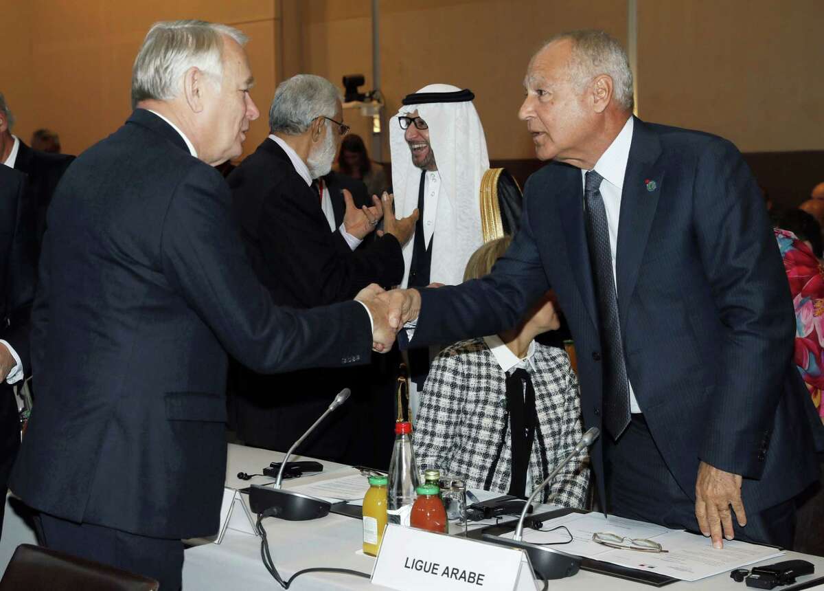 French Minister of Foreign Affairs Jean-Marc Ayrault, left, shakes hands with Arab League Secretary General Ahmed Aboul-Gheit at the opening of the Mideast peace conference in Paris on Jan. 15, 2017. Fearing a new eruption of violence in the Middle East, more than 70 world diplomats gathered in Paris on Sunday to push for renewed peace talks that would lead to a Palestinian state.