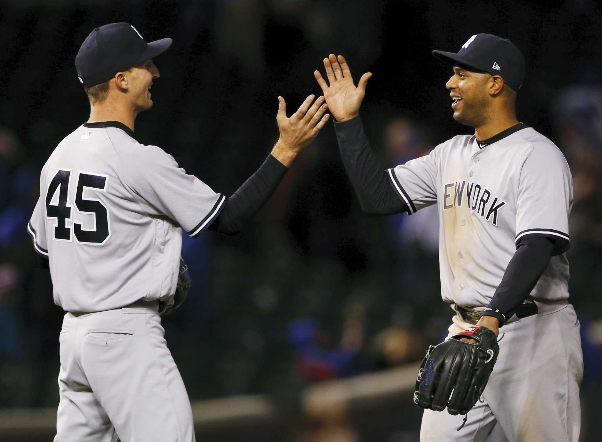 Chicago Cubs' Jon Jay, left, and Javier Baez celebrate after