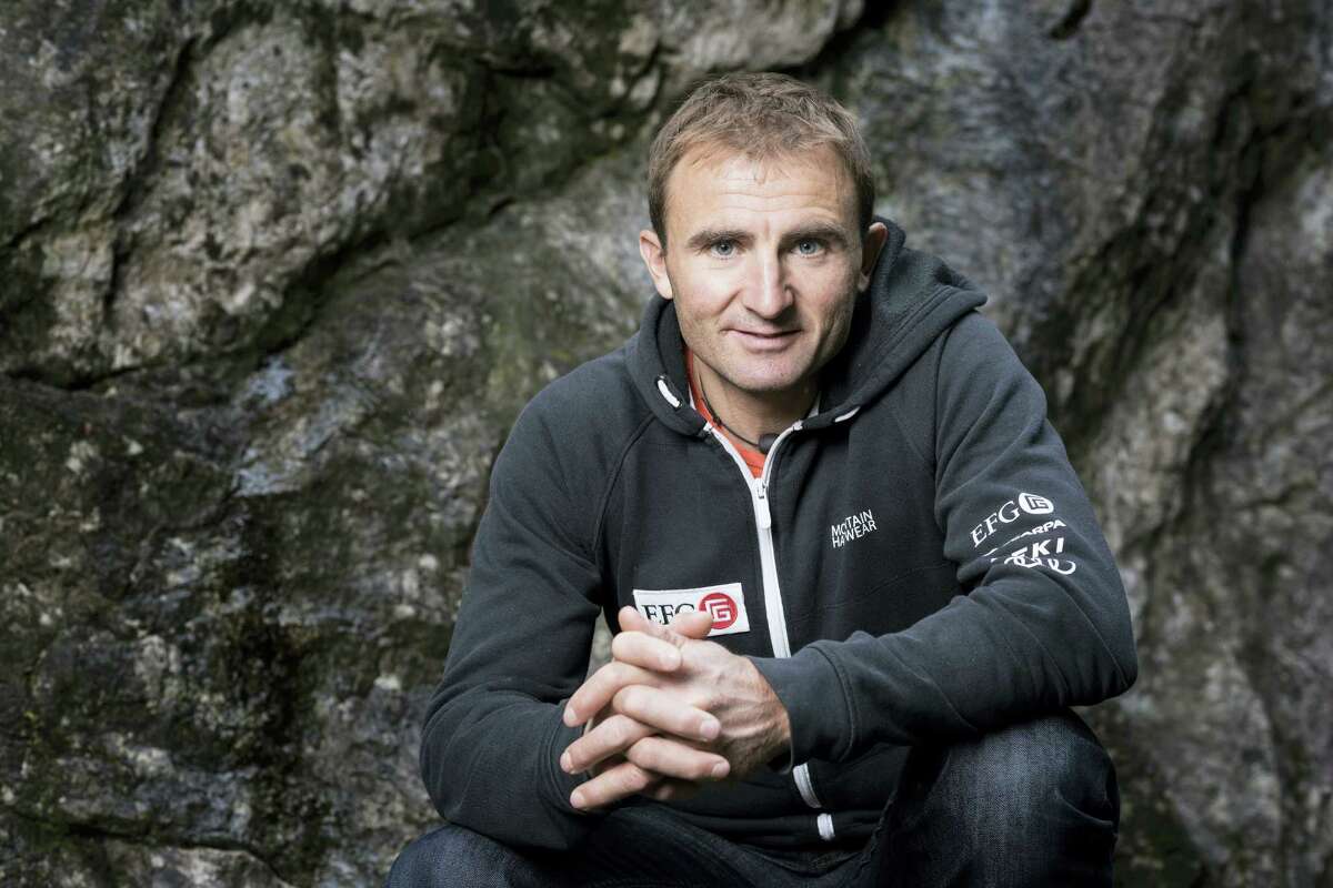 In this Sept. 11, 2015 photo, Swiss climber Ueli Steck poses for a photo at the foot of a climbing wall in Wilderswil, Canton of Berne, Switzerland. Expedition organizers say famed Swiss climber Ueli Steck was killed in a mountaineering accident near Mount Everest in Nepal.