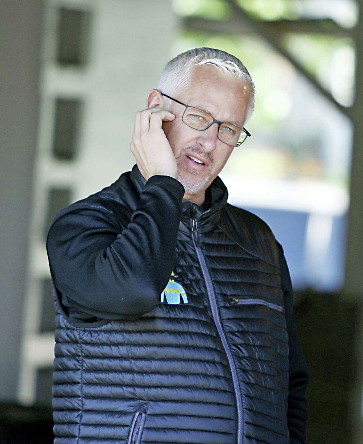 Trainer Todd Pletcher watches activities outside his barn at Churchill Downs.