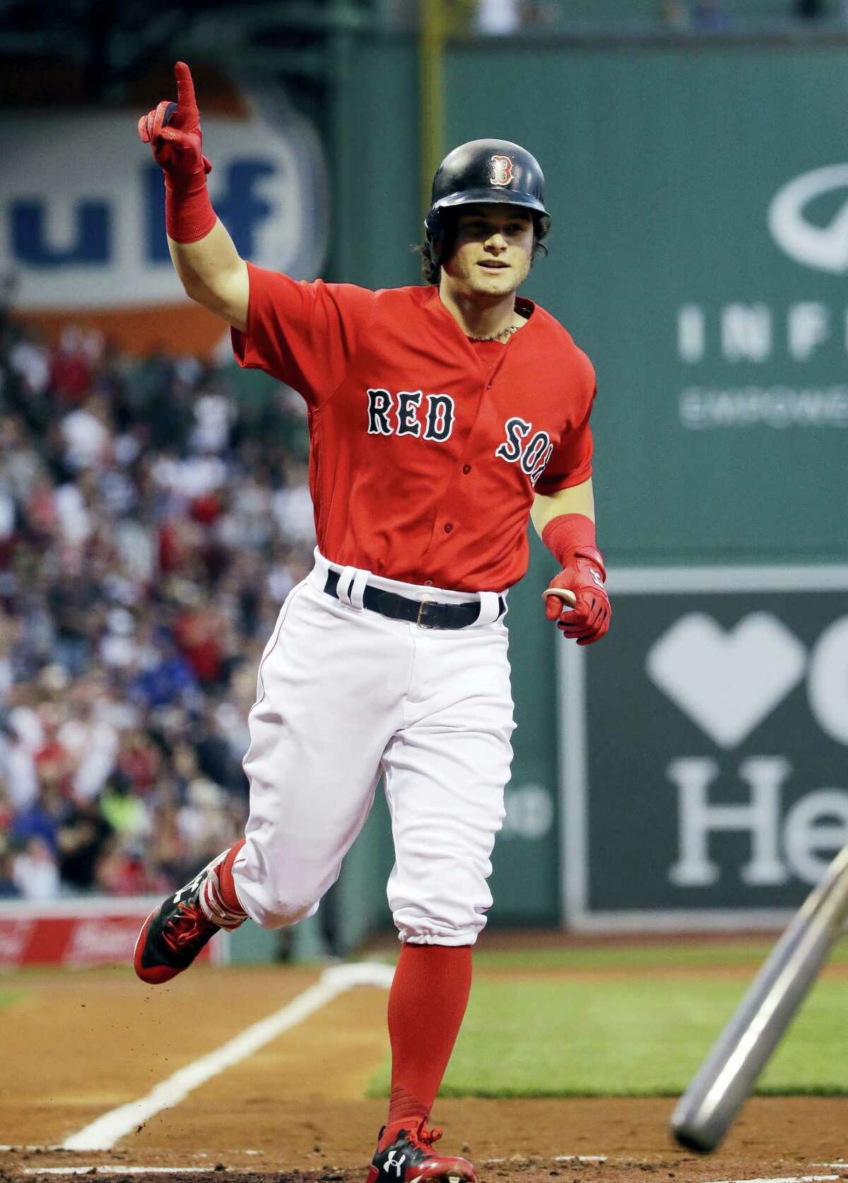 Boston Red Sox’s Andrew Benintendi gestures as he crosses the plate with a solo home run during the first inning of the team’s baseball game against the Chicago Cubs at Fenway Park, Friday in Boston.
