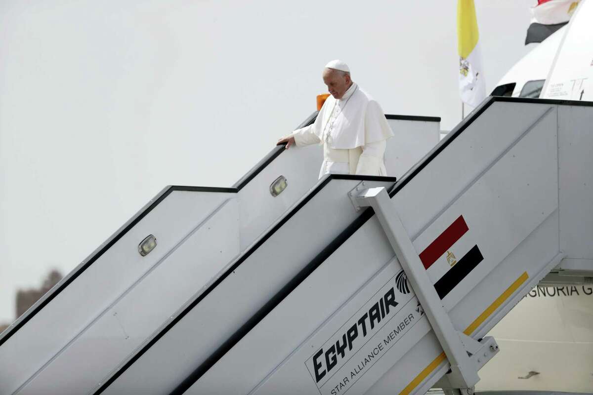 Pope Francis walks down the steps of the airplane upon arriving at Cairo’s airport, Egypt, Friday, April 28, 2017. Francis is in Egypt for a two-day trip aimed at presenting a united Christian-Muslim front that repudiates violence committed in God’s name.