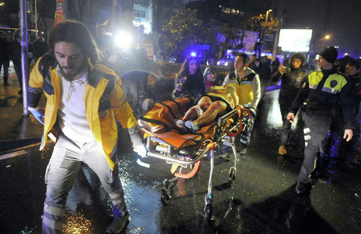 Medics carry a wounded person at the scene after an attack at a popular nightclub in Istanbul.