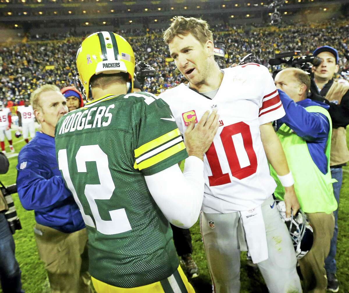The Packers’ Aaron Rodgers talks to Giants quarterback Eli Manning after a game earlier this season.