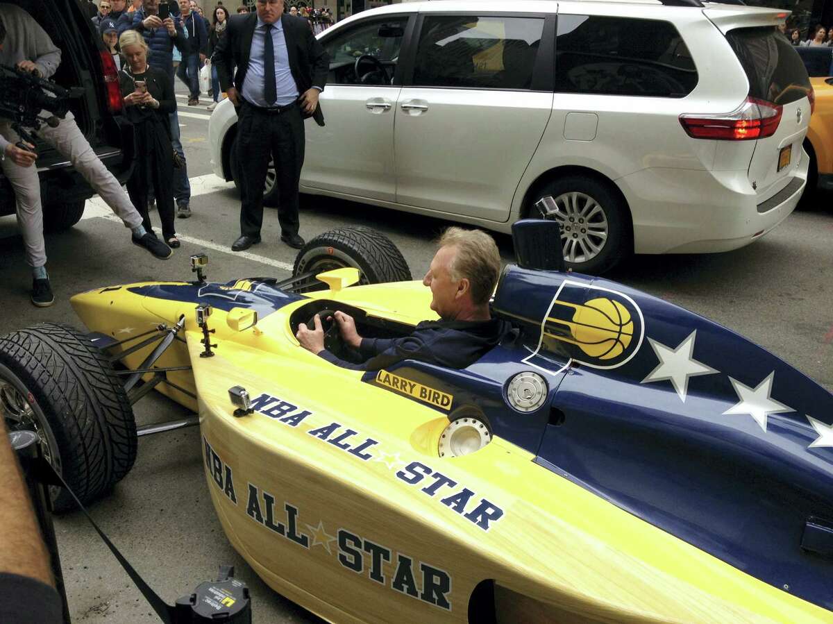 Indiana Pacers president Larry Bird sits in an Indy car in New York, Monday. Bird drove four blocks down Fifth Avenue in the car to deliver the basketball team’s bid to host the 2021 game to NBA Commissioner Adam Silver.