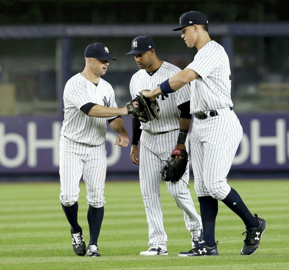 New York Yankees’ Brett Gardner, left, Jacoby Ellsbury, center, and Aaron Judge celebrate in the outfield after the baseball game against the Chicago White Sox at Yankee Stadium, Wednesday, April 19, 2017, in New York. The Yankees defeated the White Sox 9-1. (AP Photo/Seth Wenig)