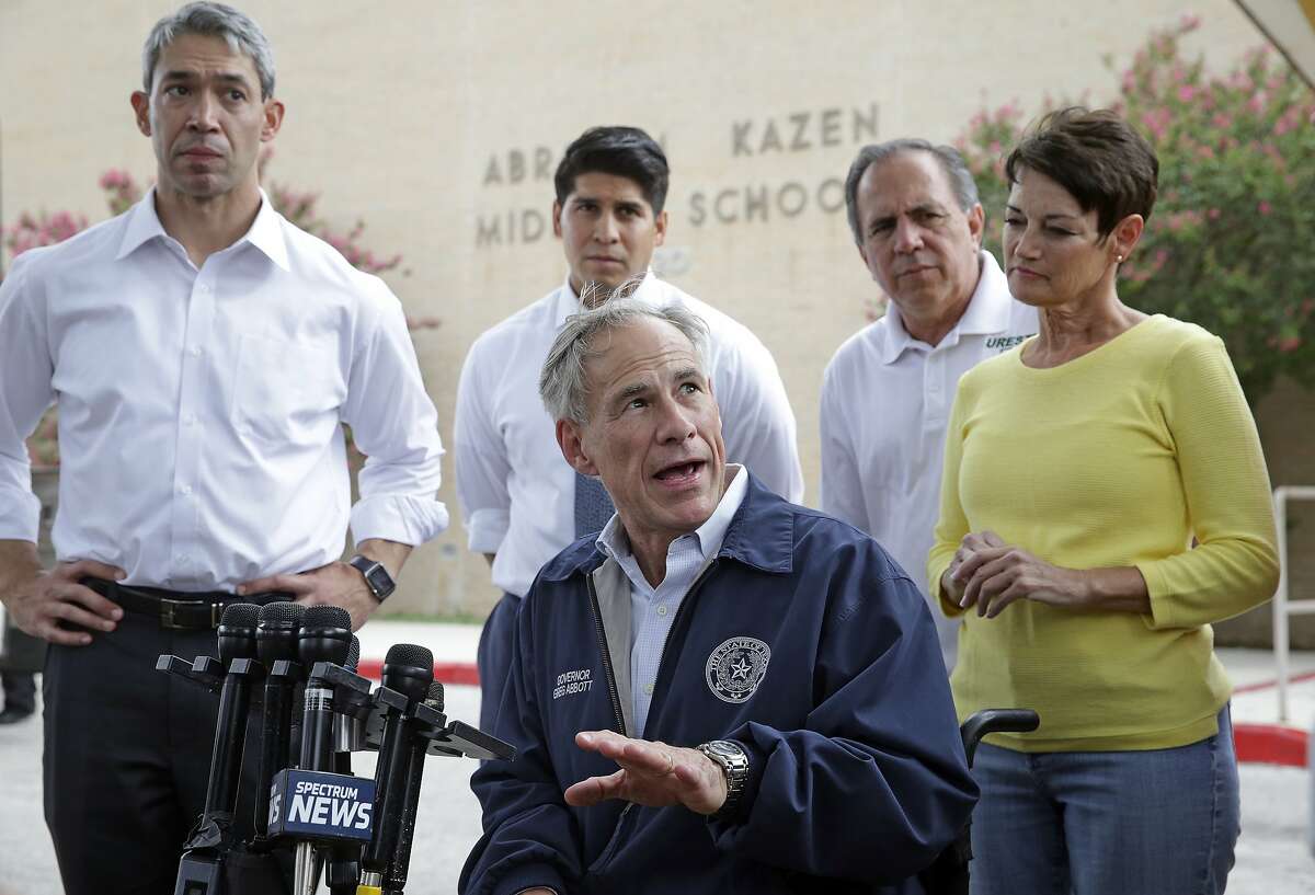 Governor Greg Abbott speaks after he greets evacuees as they arrive at Kazen Middle School on San Antonio's southside on August 25, 2017. Listening are Mayor Ron Nirenberg, Councilman Rey Saldana, Representative Tomas Uresti and Senator Donna Campbell.
