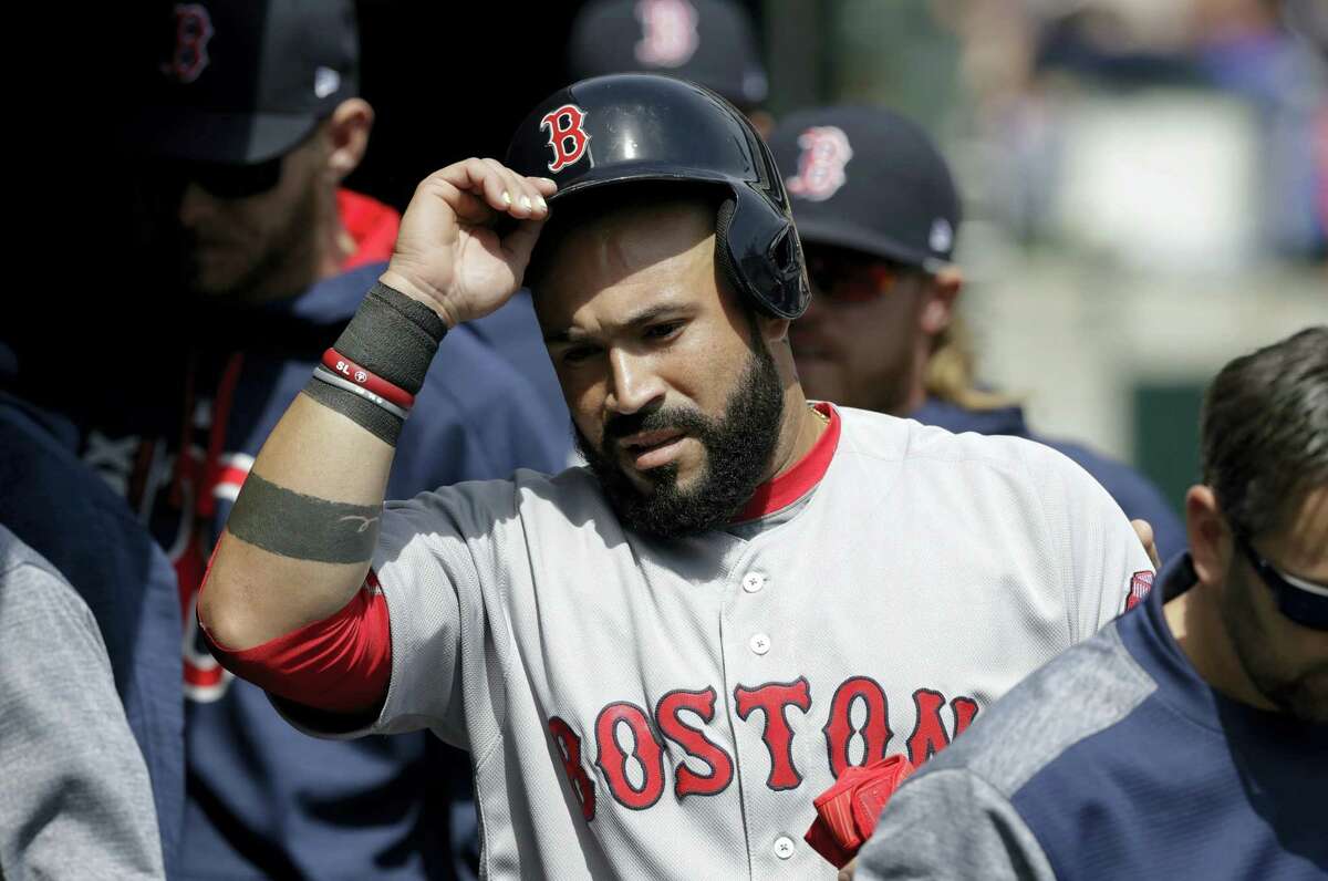 Boston Red Sox’s Sandy Leon enters the dugout after scoring from third on a single by Marco Hernandez during the second inning of a baseball game against the Detroit Tigers on April 9, 2017 in Detroit.