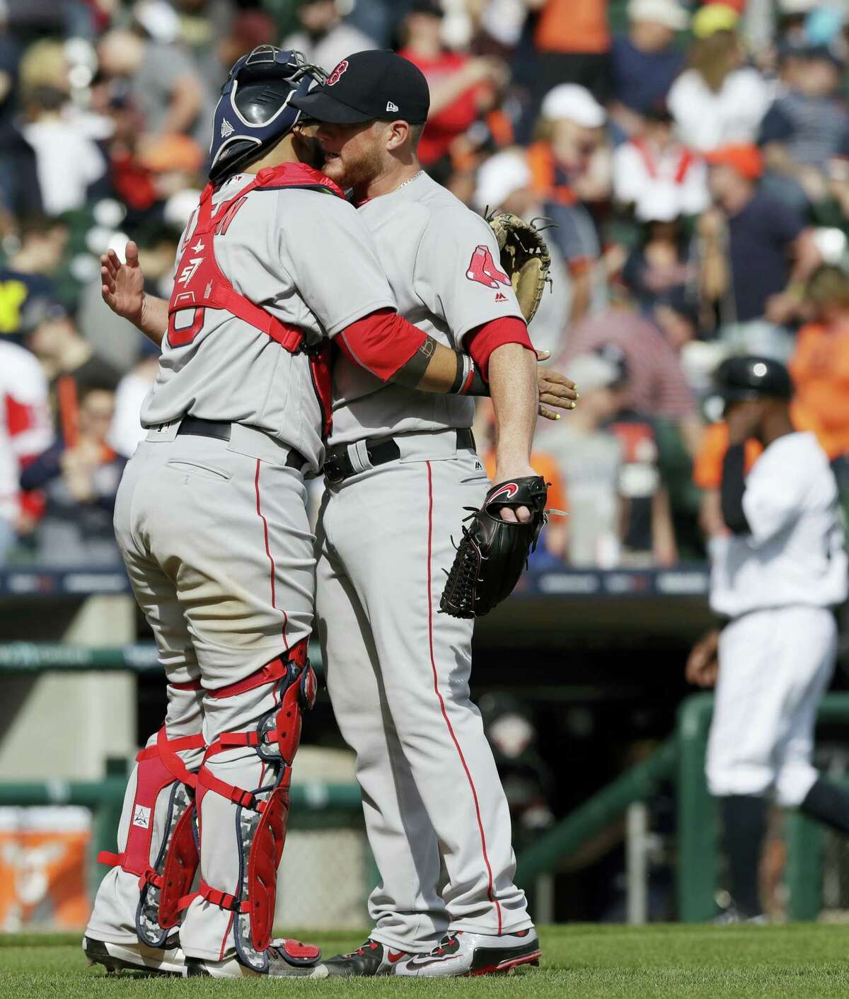 Boston Red Sox relief pitcher Craig Kimbrel is hugged by catcher Sandy Leon after the team’s 7-5 win over the Detroit Tigers in a baseball game on April 9, 2017 in Detroit.