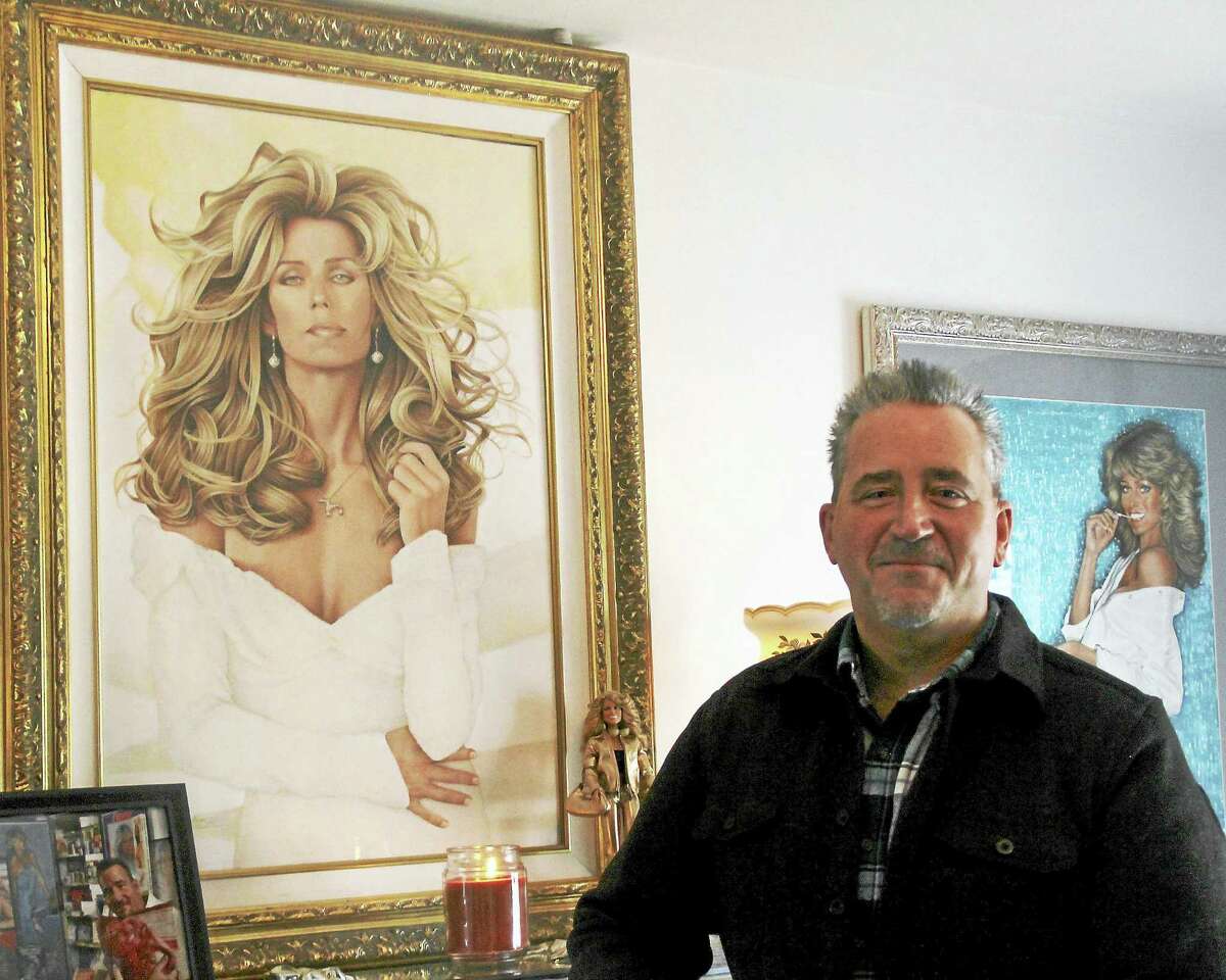 Andrew Morro poses next to a portrait of Farrah Fawcett he commissioned to artist Jonathan Dwayne, of Puerto Rico. Though Fawcett is well-known for a sunning smile, filled with Chiclet-like, super white teeth, Morro preferred a more elegant look, he said.