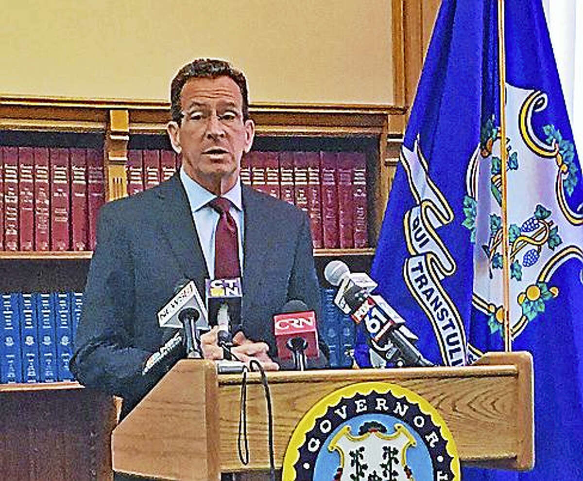 Gov. Dannel P. Malloy speaks with reporters Friday at the state Capitol in Hartford.