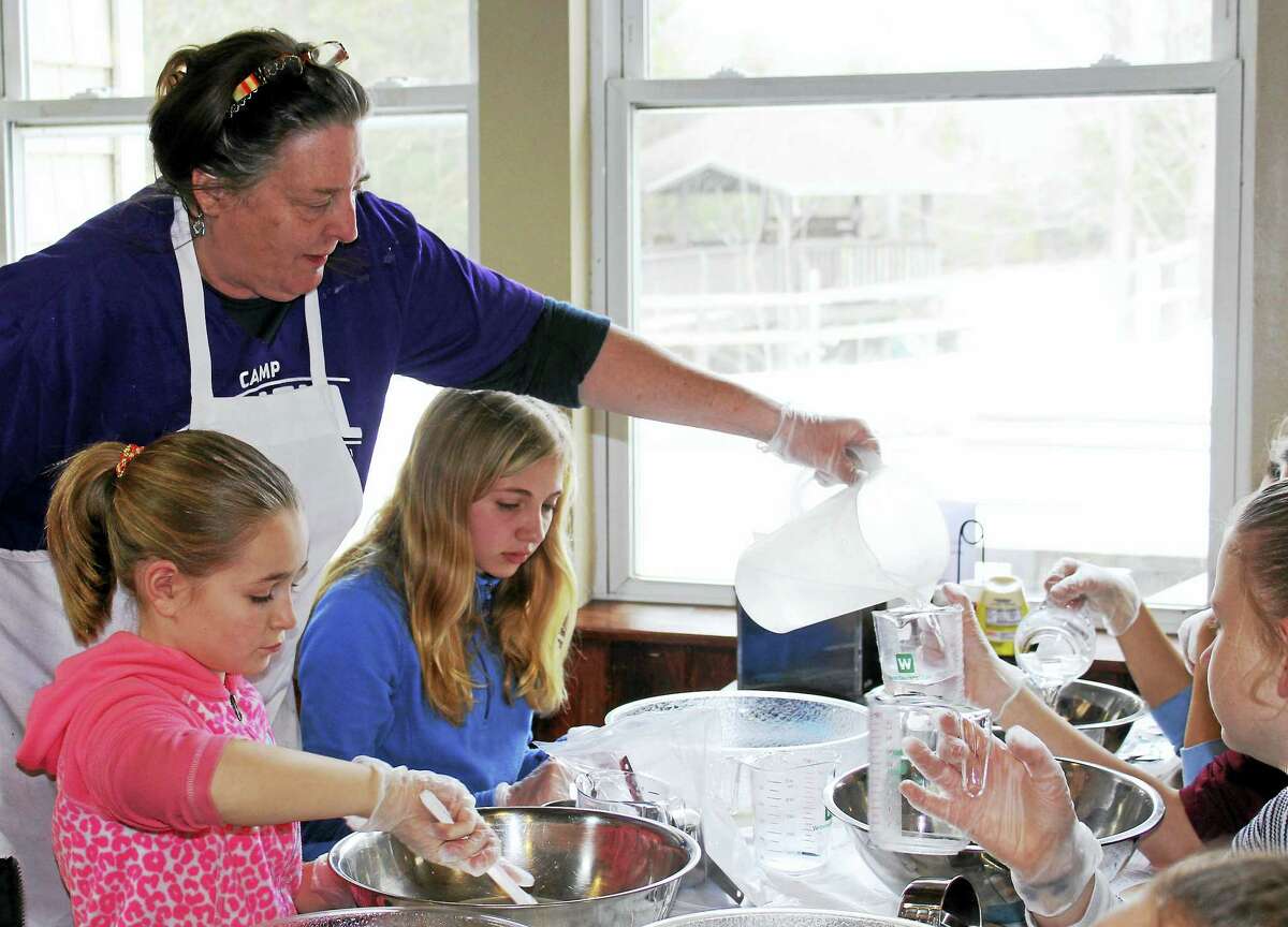 Contributed photosLisa Coyne, a cook at Camp Jewell, teaches a group of Girl Scouts to make bread.
