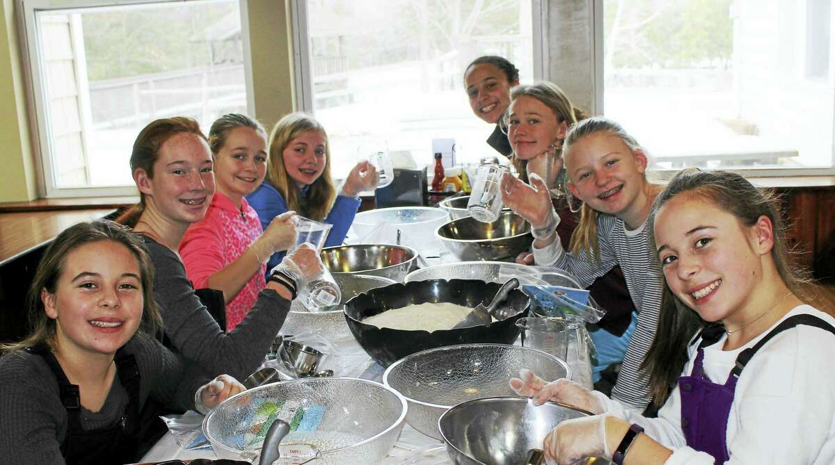 Contributed photo A group of Girl Scouts making bread as part of Camp Jewell’s King Arthur Bake for Good program.