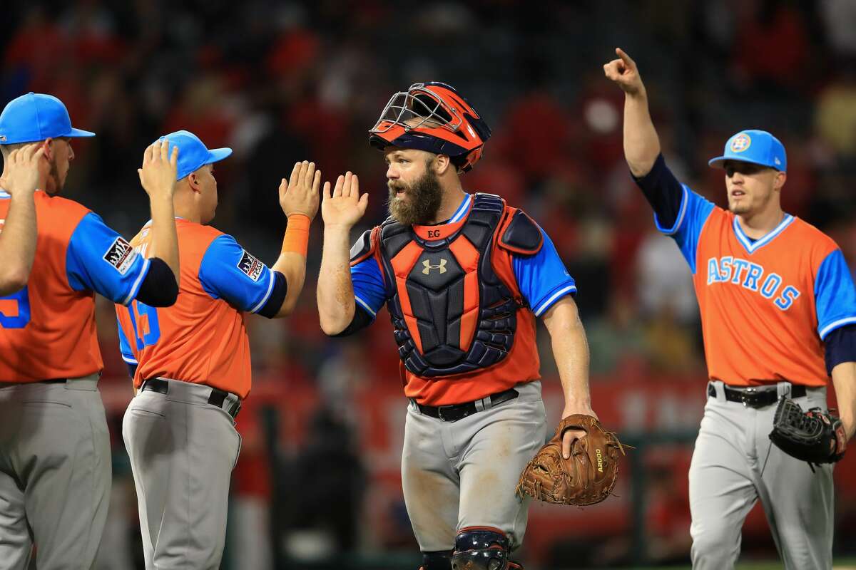 ANAHEIM, CA - AUGUST 25: Evan Gattis #11 and Ken Giles #53 of Houston Astros react after defeating the Los Angeles Angels of Anaheim 2-1 in a game at Angel Stadium of Anaheim on August 25, 2017 in Anaheim, California. (Photo by Sean M. Haffey/Getty Images)